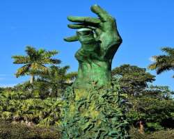 The focus of the memorial is a 42-foot-high bronze arm rising from the ground; sculptured people climb it, looking for an escape. The panels bear the 